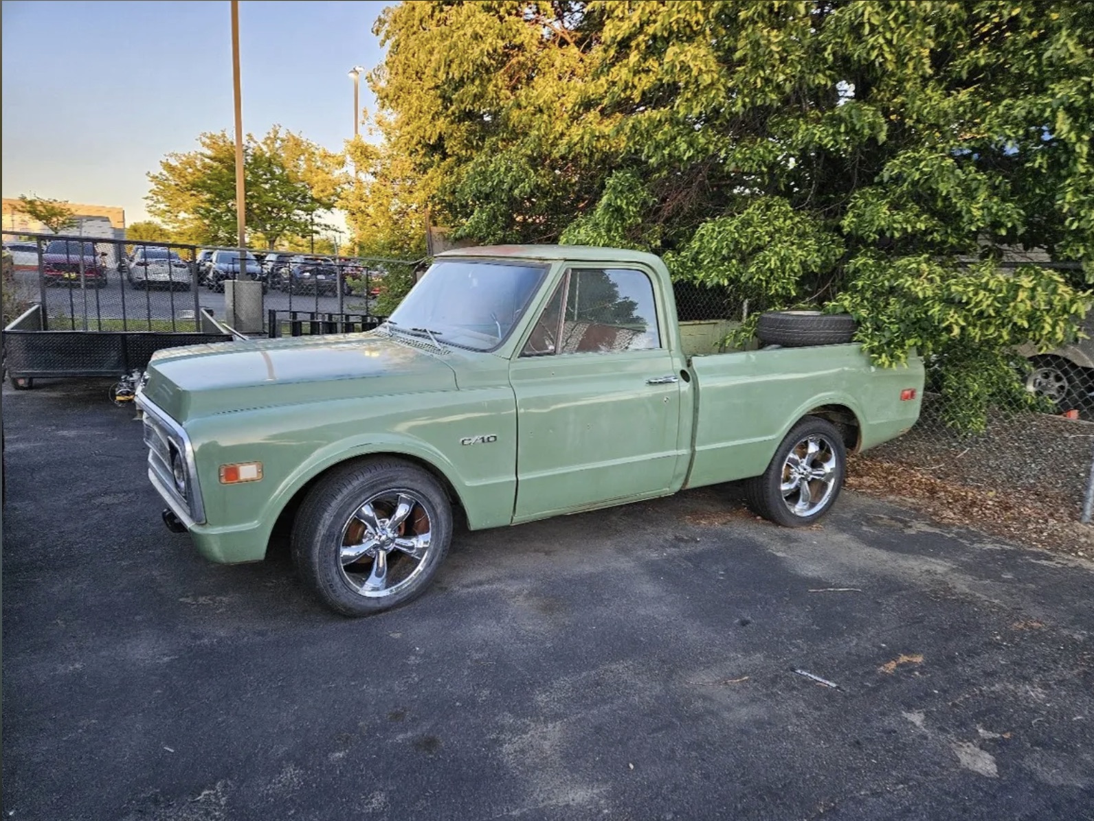 Classic green Chevy C10 pickup truck with chrome wheels at Boise Automotive Service